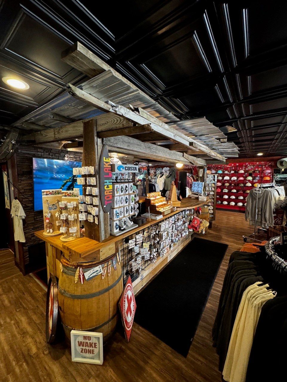 The register counter with a NO WAKE ZONE sign at its foot and the red hat wall behind